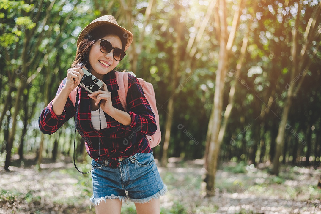 Mulher asiática de beleza sorrindo retrato de estilo de vida de uma jovem bonita se divertindo no verão ao ar livre com câmera digital.