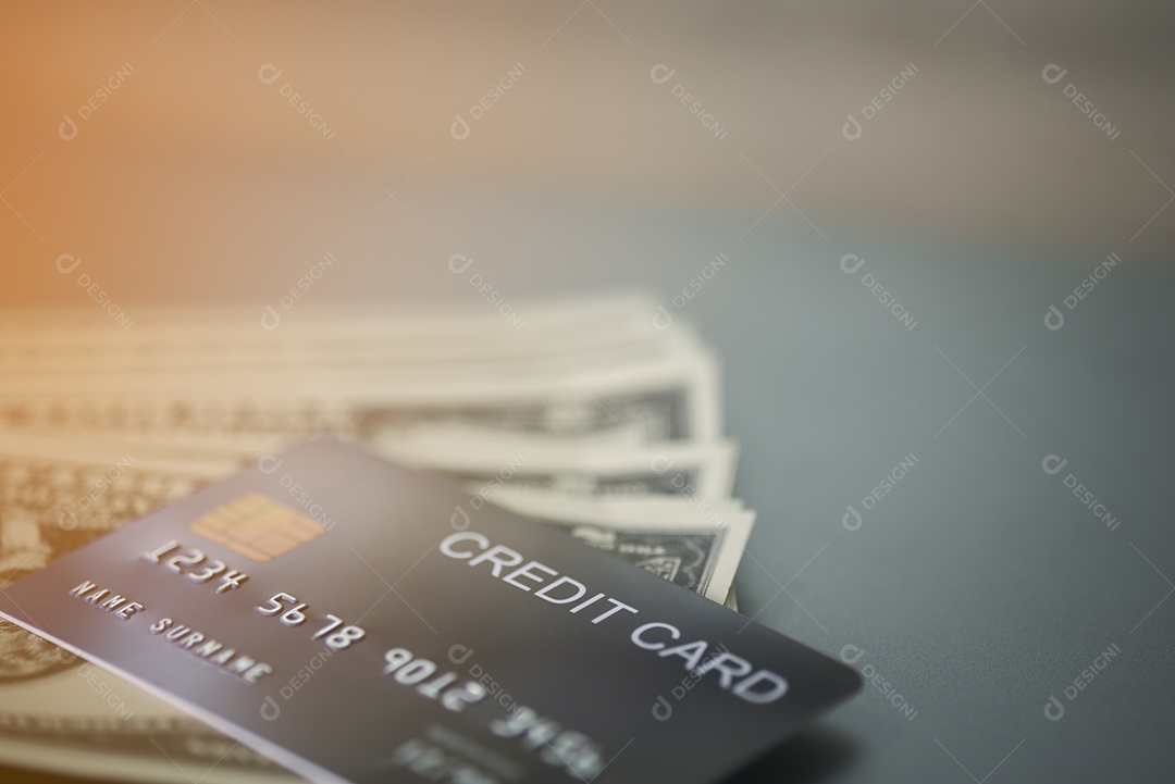 O cartão de crédito é colocado em cima da nota de dólar