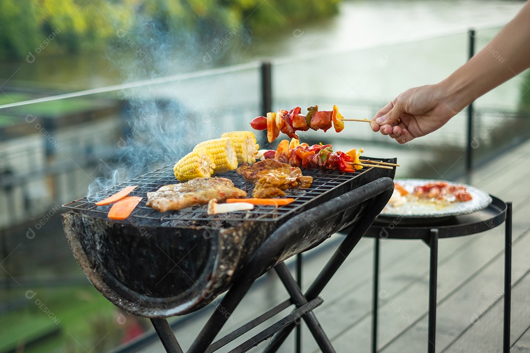 delicious grilled meat with smoke, barbecue with vegetables outdoors. Barbecue, party, lifestyle and picnic concept