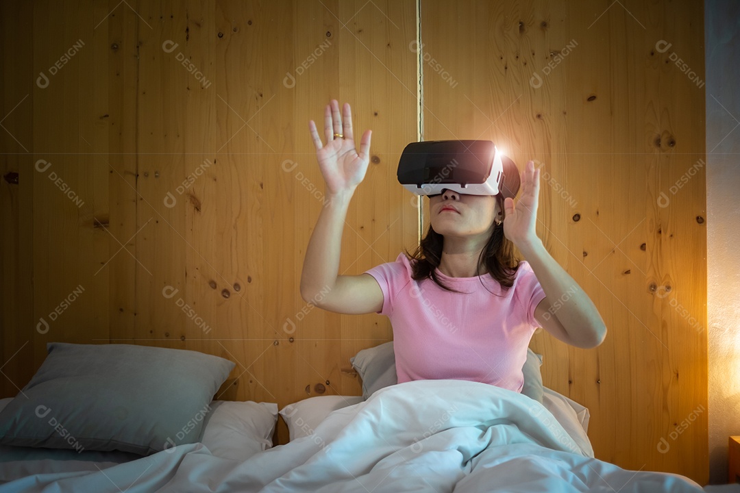 Jovem mulher usando fone de ouvido de realidade virtual na cama. VR, tecnologia digital do futuro, jogo, entretenimento de filmes
