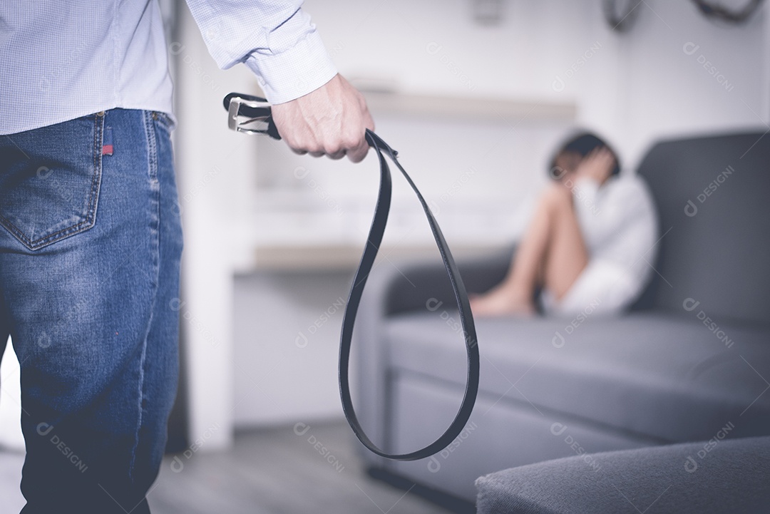 Foco seletivo do cinto na mão do homem estressado contra menina.