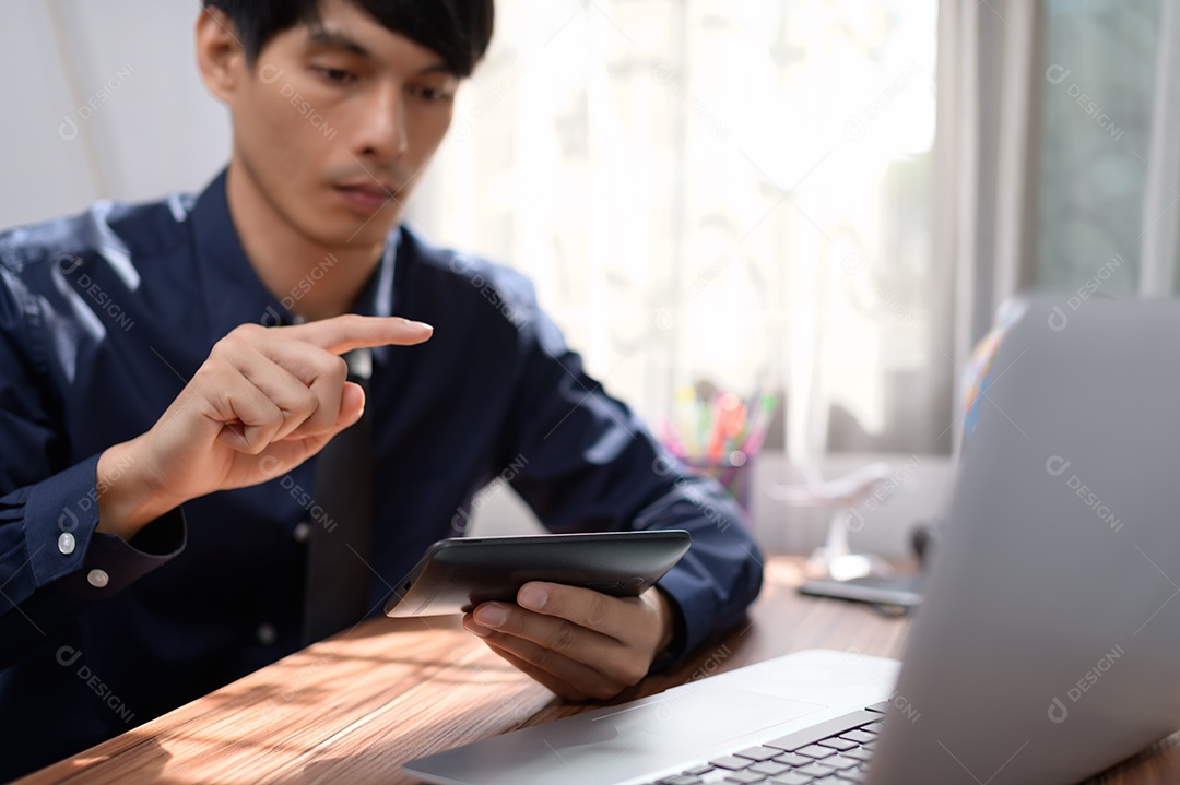 Empresário trabalhando na frente de um notebook em uma mesa