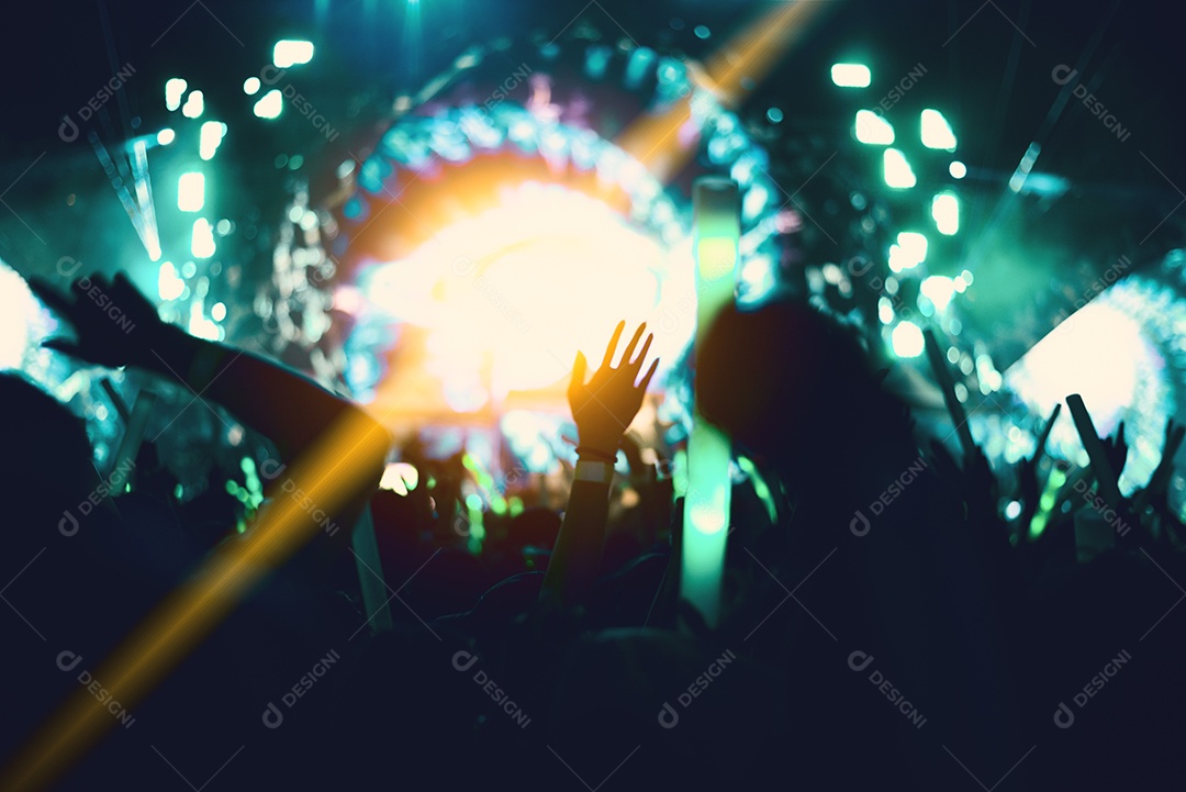 Rock concert with silhouette people in happy gesture.