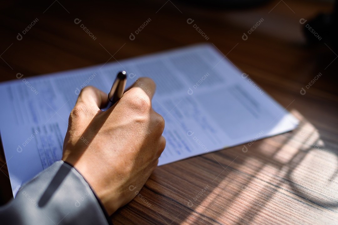 Empresário lendo e escrevendo livro no trabalho