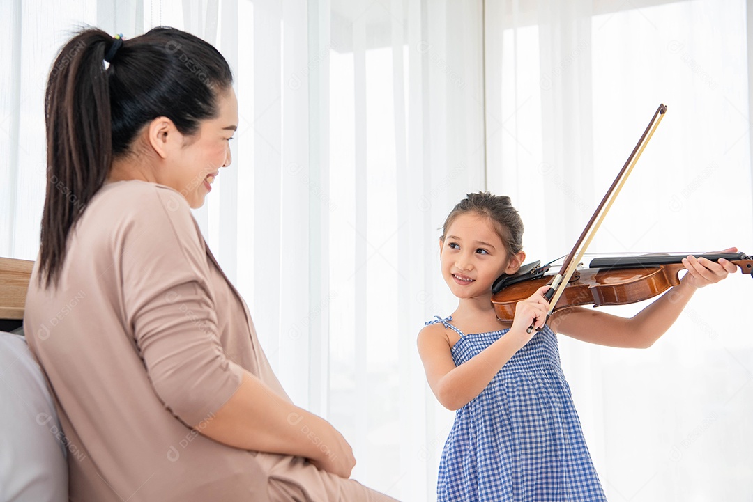 Menina tocando violino com a mãe grávida para canção de ninar recém-nascido na barriga da mãe. Conceito musical e de entretenimento.