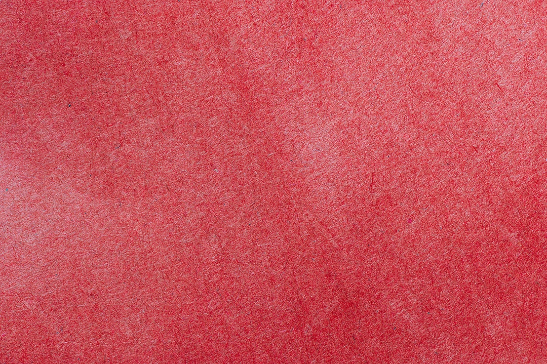 Papel de parede de fundo texturizado de papel vermelho. Detalhes aproximados do material.