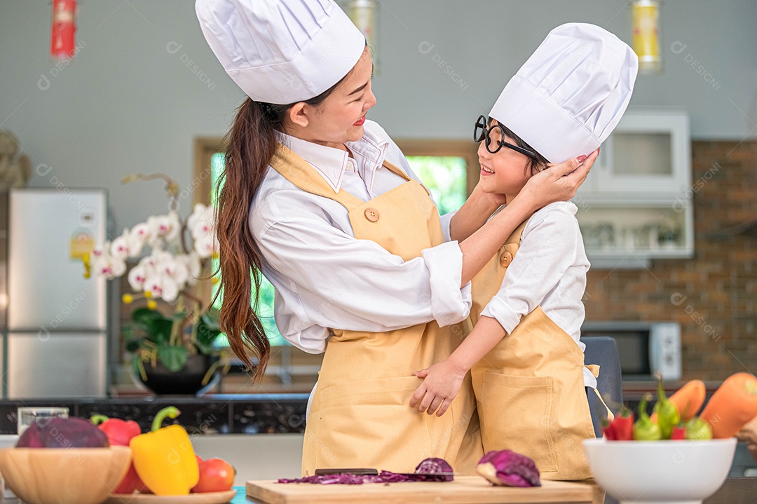 Happy cute little boy with glasses looking at handsome Asian.