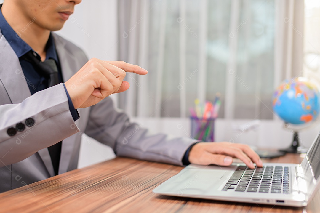 Homem de negócios que usando o computador portátil no escritório