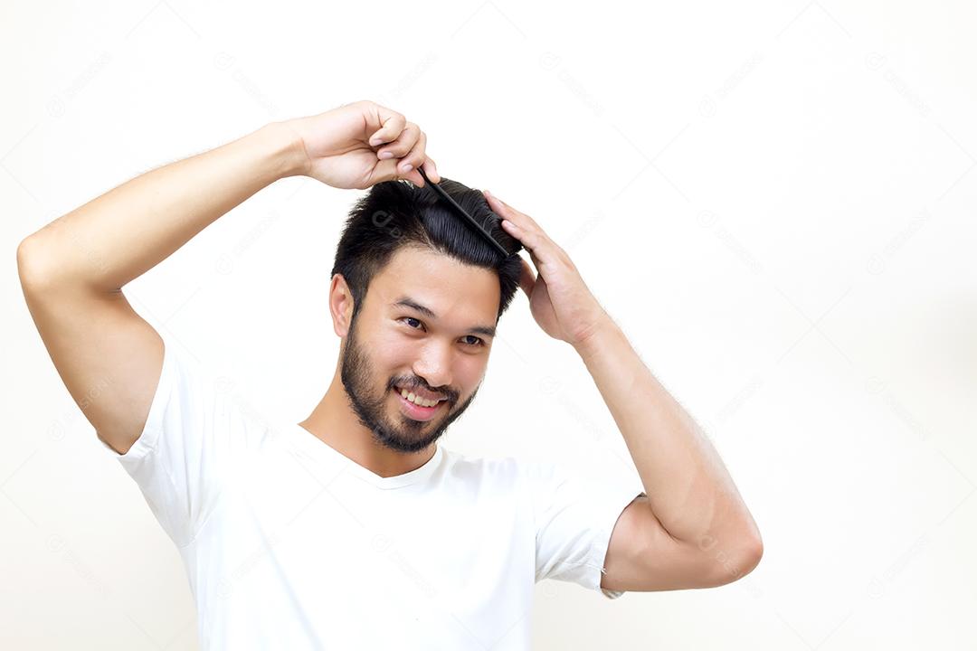 conceito de pessoas - jovem sorridente, escovando o cabelo com pente no fundo branco