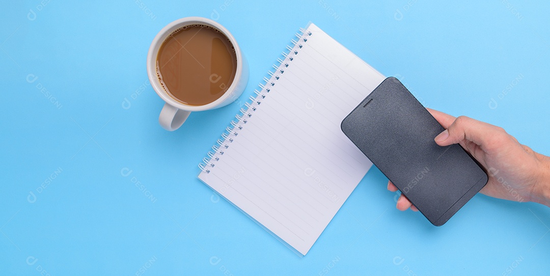 Caneca de café, livro, smartphone em um fundo azul