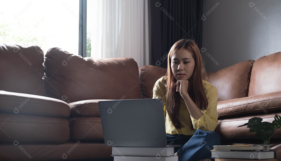 Bela jovem asiática usando laptop para estudar