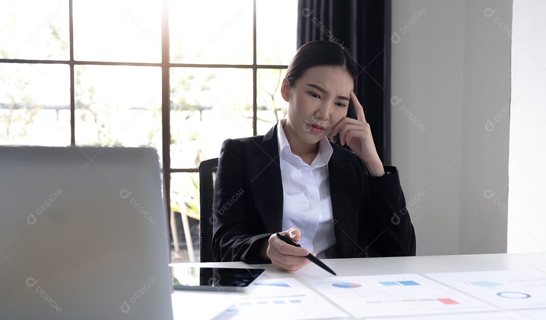 Imagem de uma mulher asiática que está cansada e pensando demais no trabalho