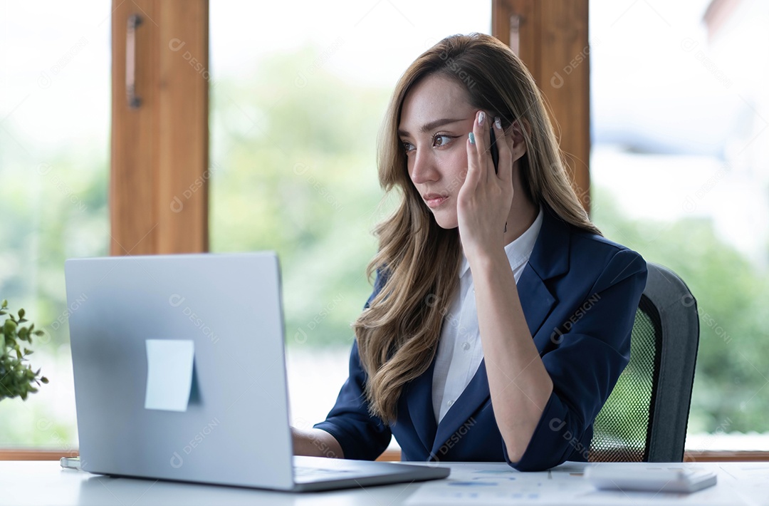 Imagem de uma mulher asiática que está cansada e pensando demais no trabalho