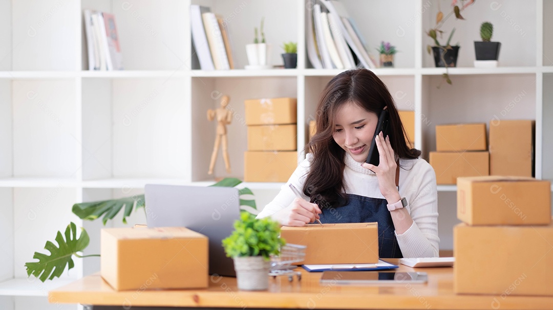 Jovem linda e feliz empresária asiática proprietária da pequena empresa online