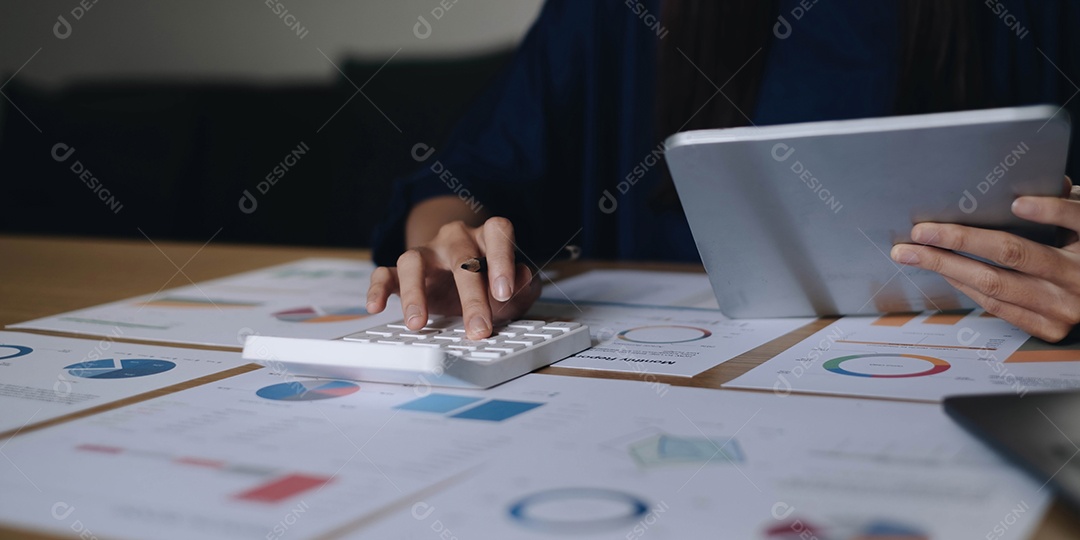 Empresária usando calculadora e laptop para calcular finanças, impostos, contabilidade