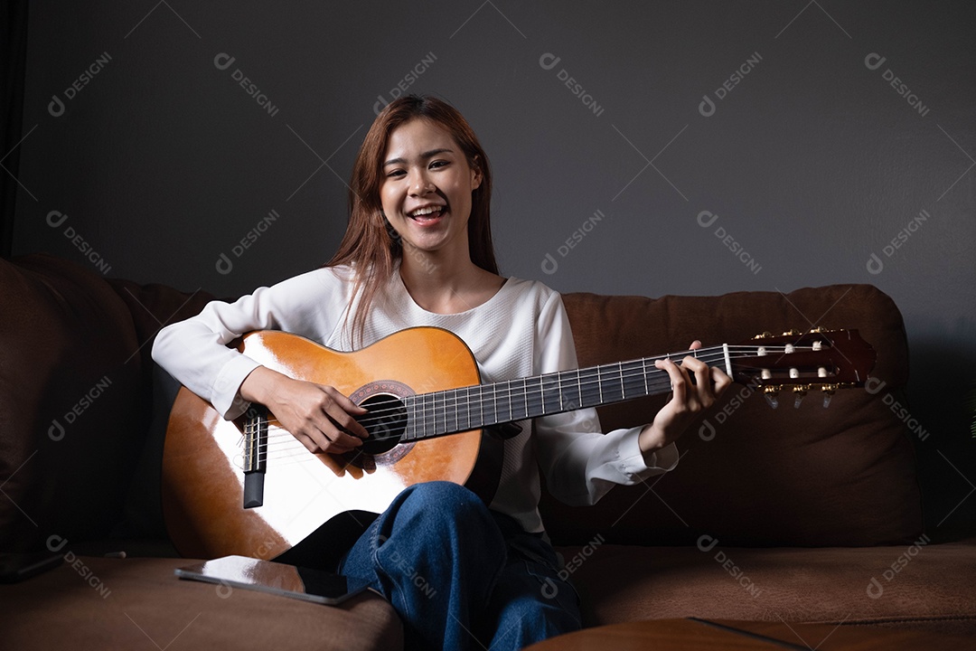 Jovem sentada tocando violão