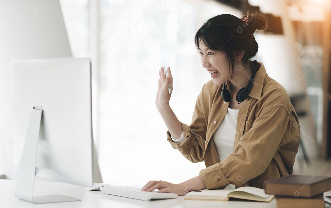 Mulher feliz e animada usando fone de ouvido olhando para laptop para videochamada
