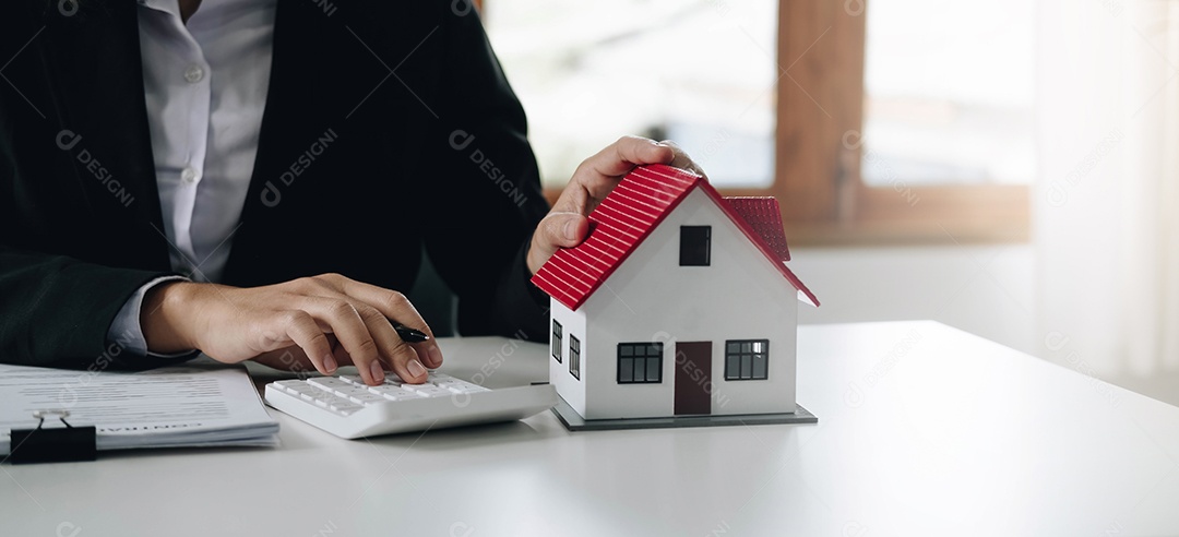 Mulher com mãos em miniatura de casa