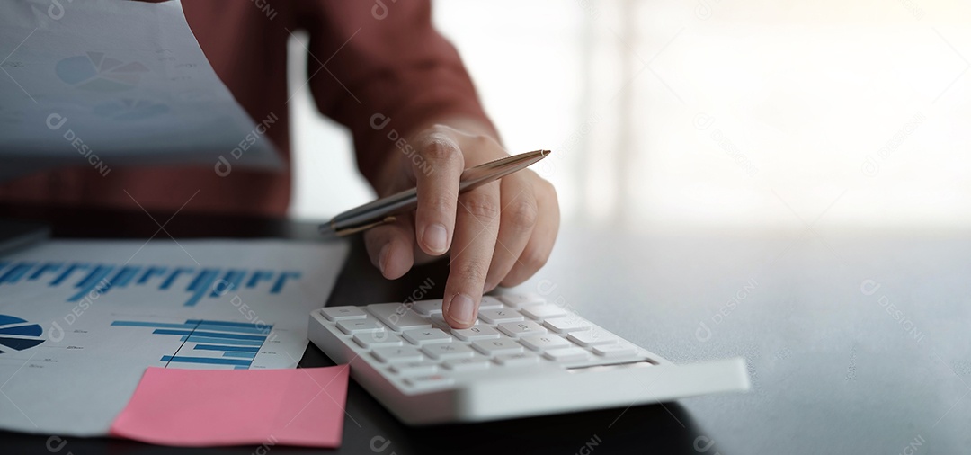 Mulher de negócios usando calculadora e laptop para fazer matemática