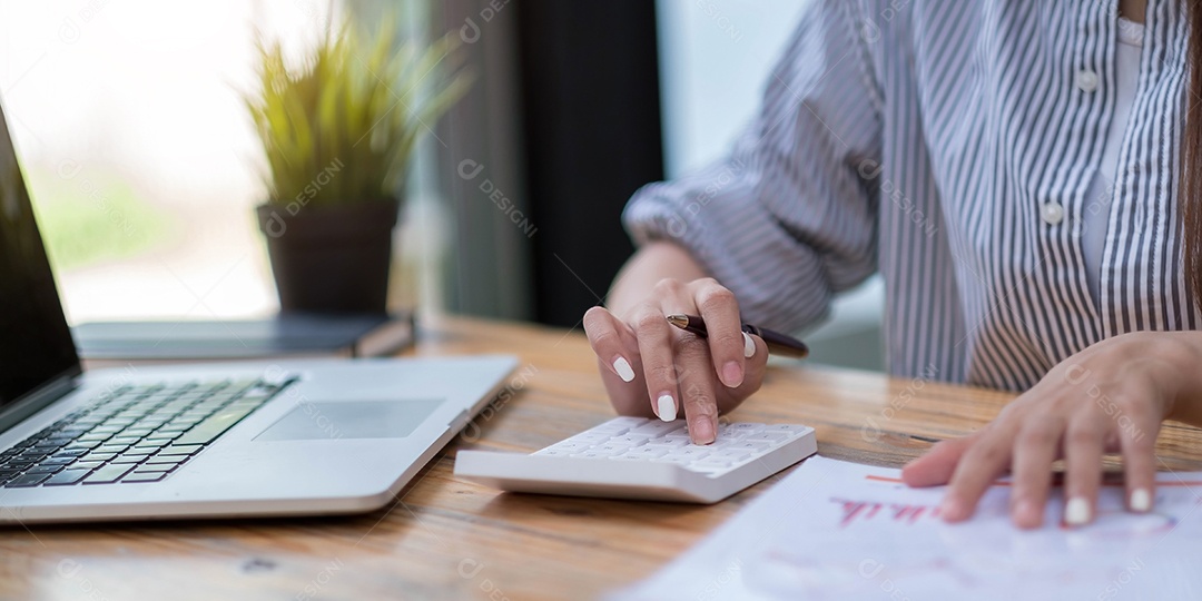 Mulher de negócios usando calculadora e laptop para fazer matemática