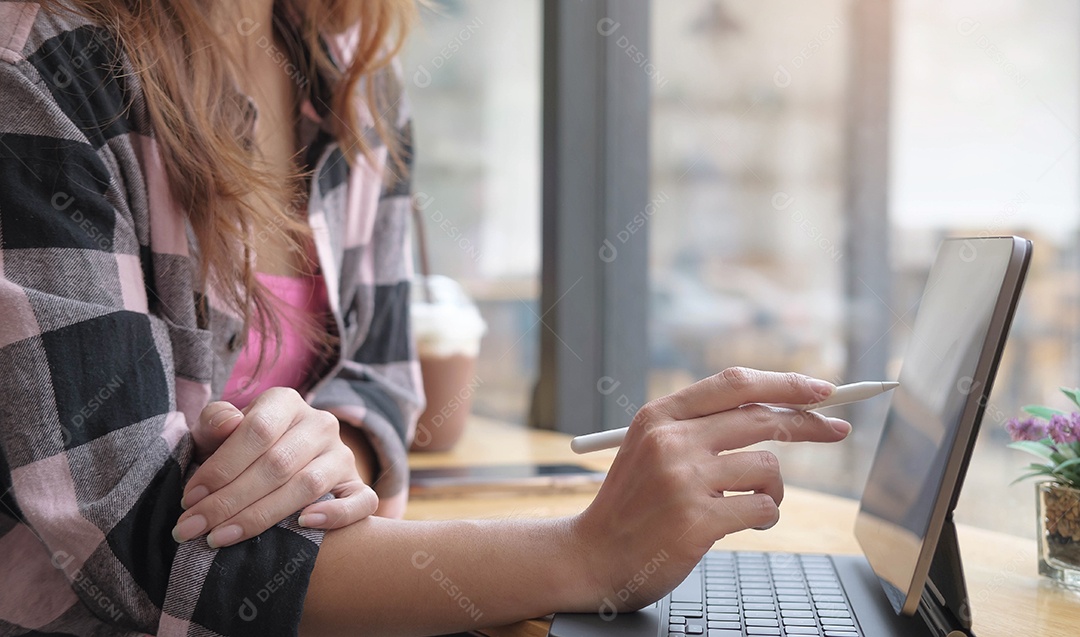 Mulher que trabalha no ponto de café para tablet.