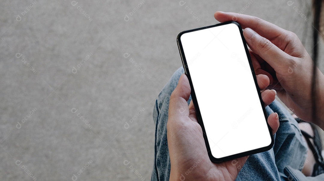 Mãos de uma mulher de negócios segurando um smartphone com tela branca em branco