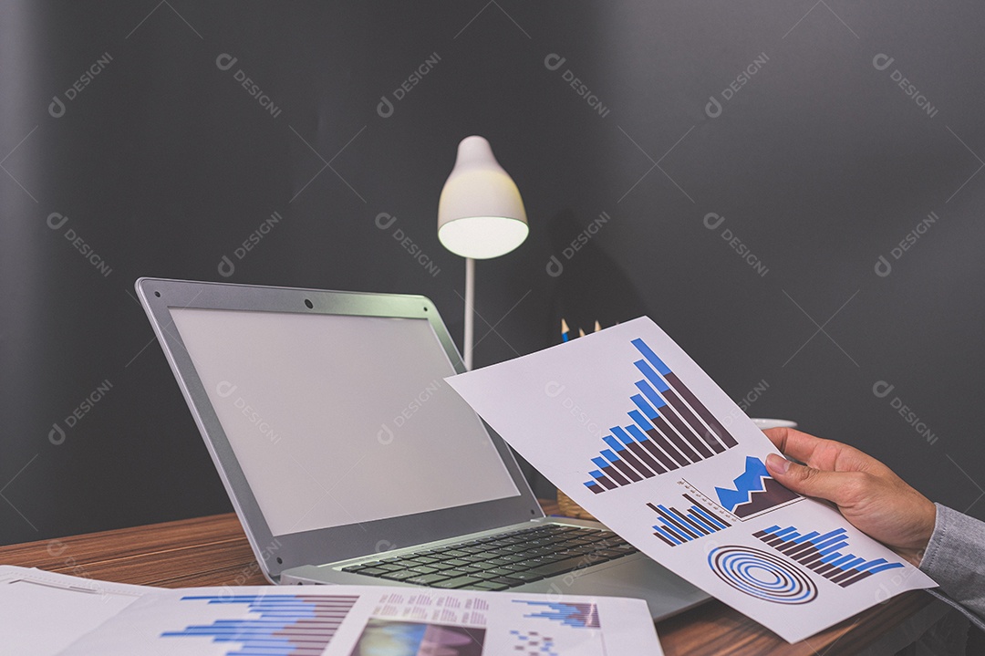 Businessman sit at work and check documents at desk in living room