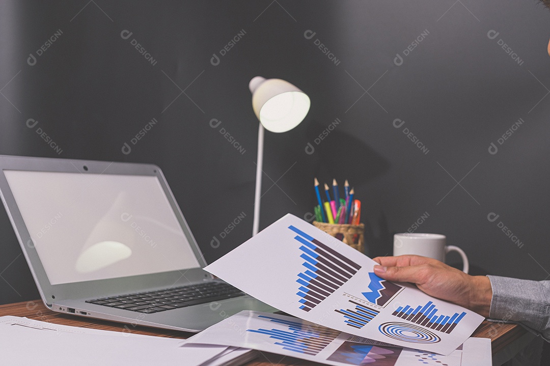 Businessman sit at work and check documents at desk in living room