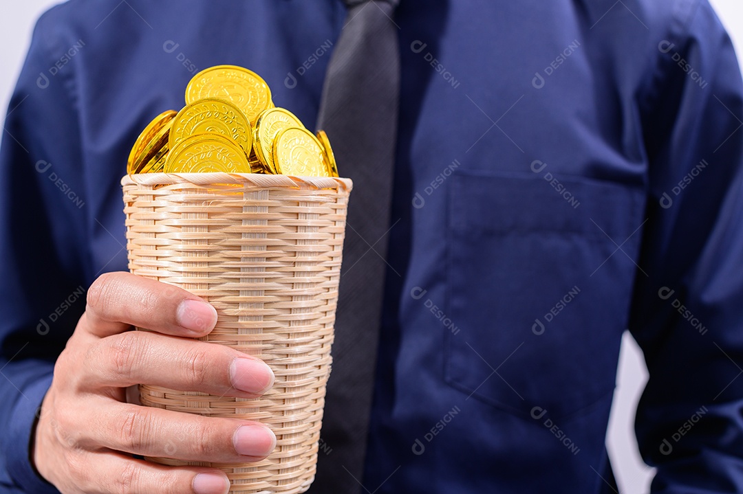 Hand holding a basket full of money