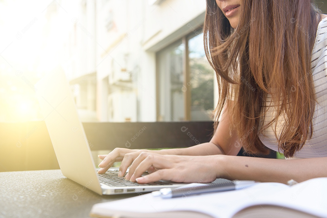 Cortada a imagem de uma mulher trabalhando em um laptop