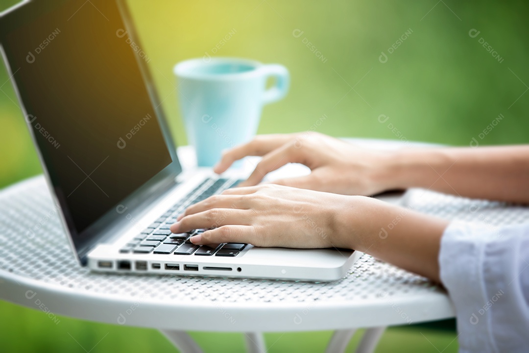 Mulher de negócios asiático usando notebook e sorrindo felizes por trabalhar ao ar livre