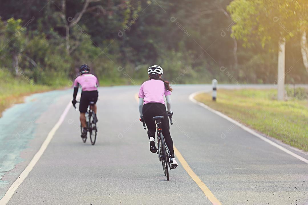 Movimento embaçado de mulheres asiáticas Ciclismo durante a corrida na estrada