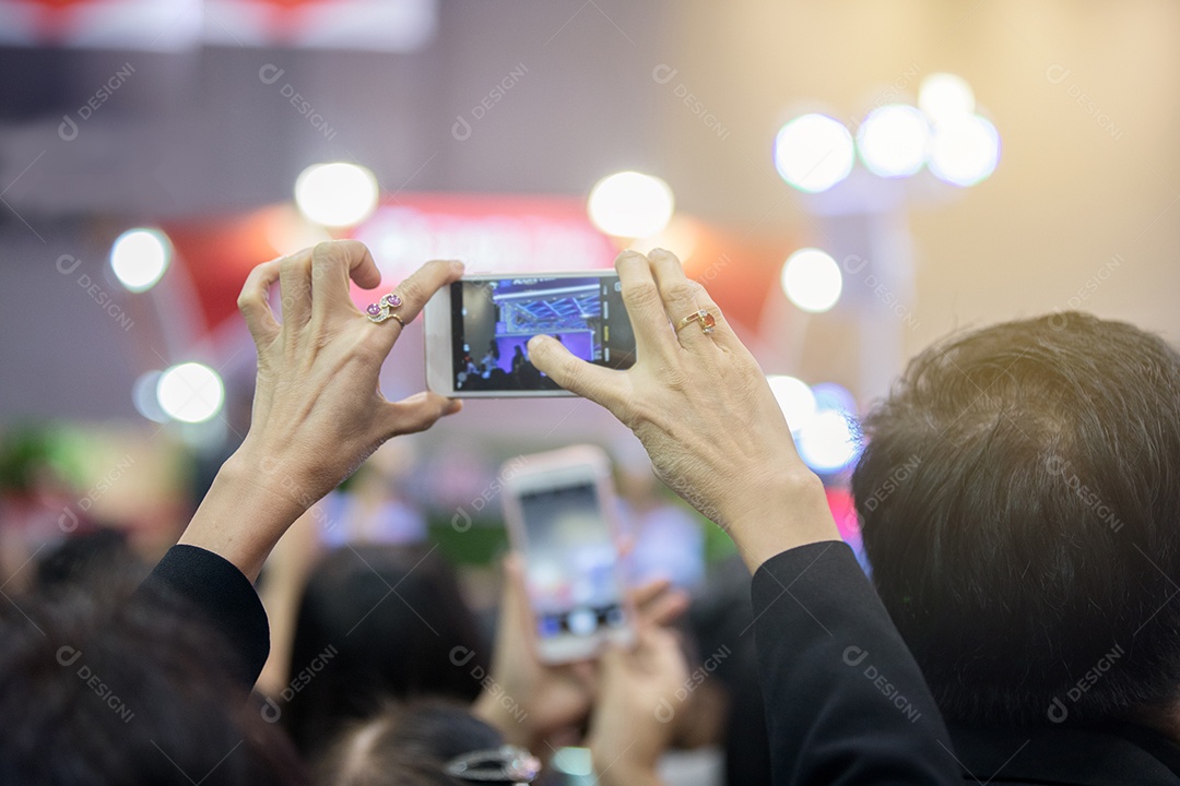 Mulher idosas asiáticas segurando smartphone e tocando na tela para tirar fotos.