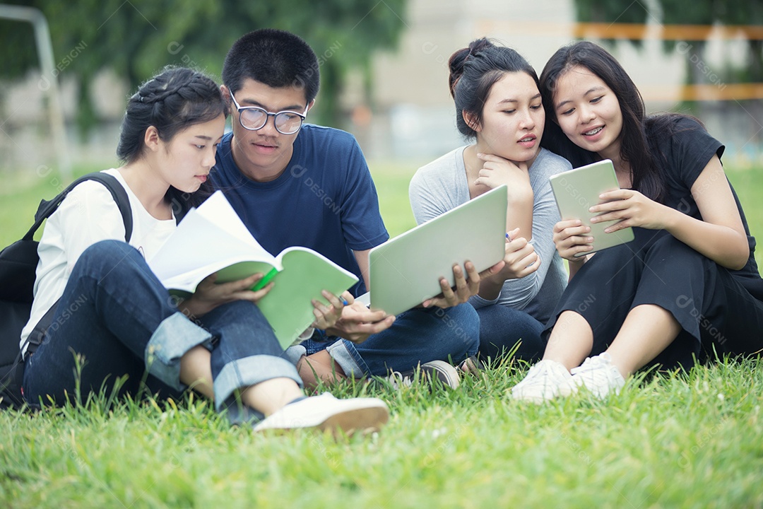 Grupo asiático de estudantes compartilhando com as ideias para trabalhar no jardim do gramado do campus