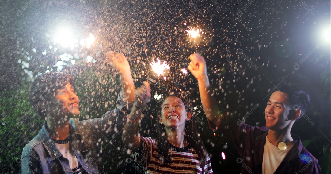 Asian group of friends having barbecue in outdoor garden laughing with alcoholic beer drinks and showing group of friends