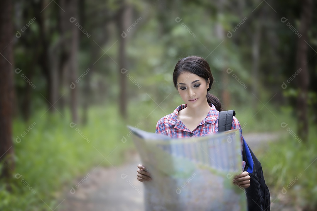 Caminhantes de mulheres jovens olhando para o mapa e relaxando no feriado concentrado