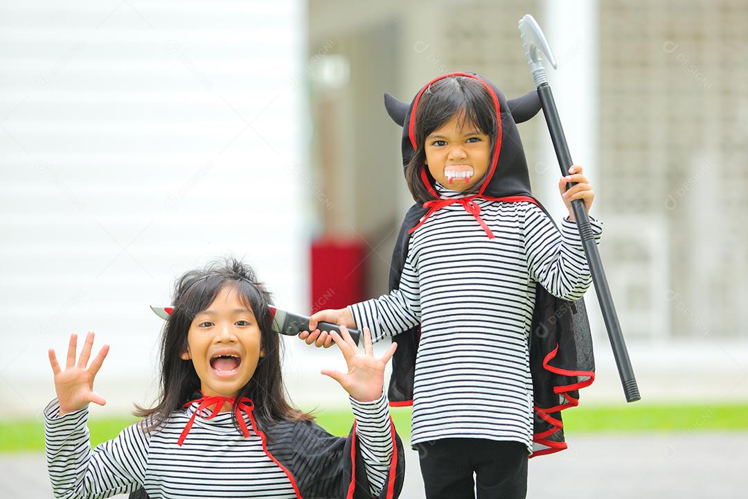 Conceito de Halloween, crianças vestidas com fantasias temáticas.