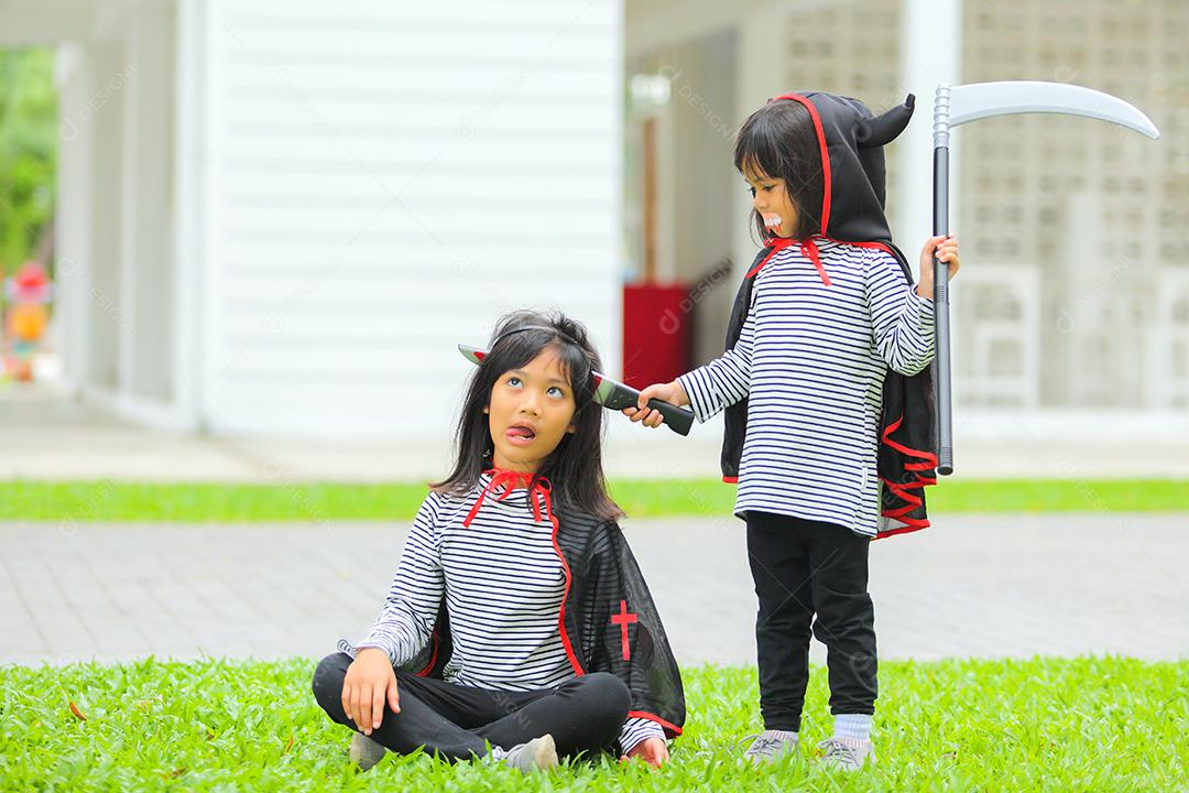 Conceito de Halloween, crianças vestidas com fantasias temáticas.