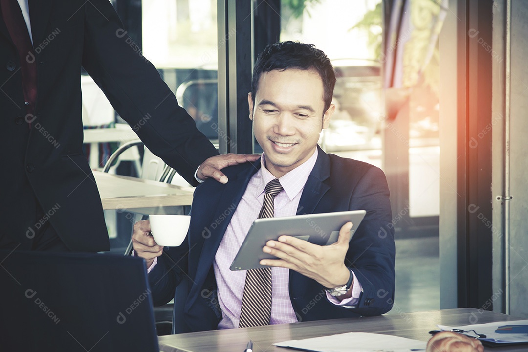 Empresário sorridente usando tablet e mostrando lucro com o chefe