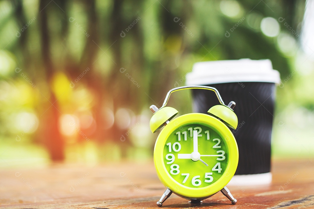 Xícara de café na mesa com cor de estilo vintage de despertador