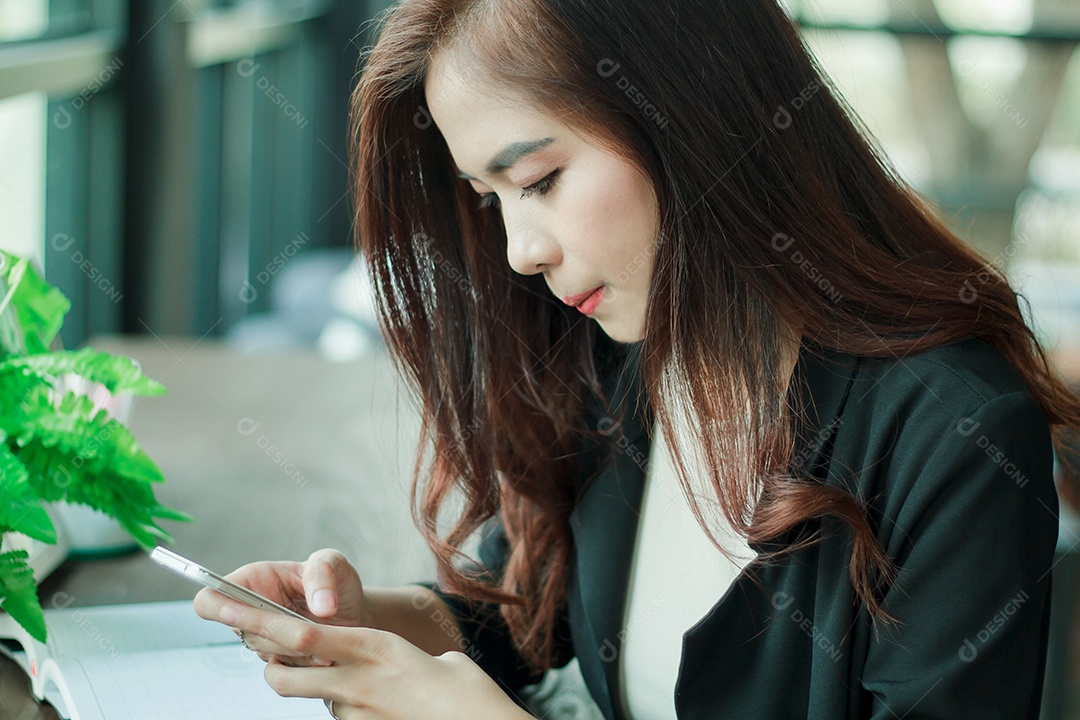 Empresários mulher estão usando telefone inteligente móvel e sensível ao toque para comunicação e verificando pessoas