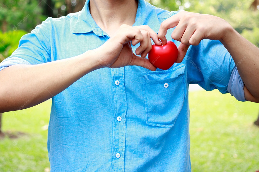 Fechar as mãos do homem com coração vermelho