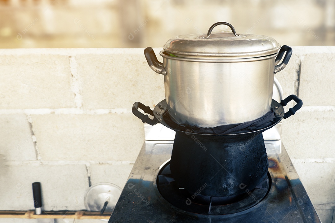 Velho conjunto de panela fumegante está no fogão a gás para cozinhar na cozinha