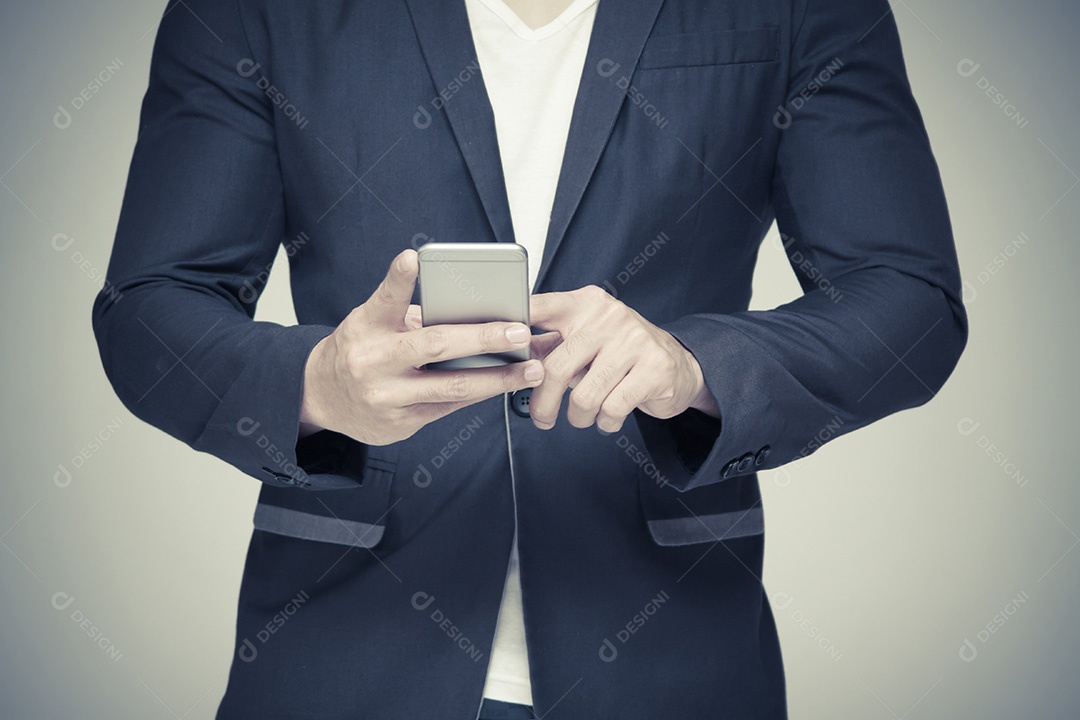 Empresário segurando o celular. sobre fundo cinza