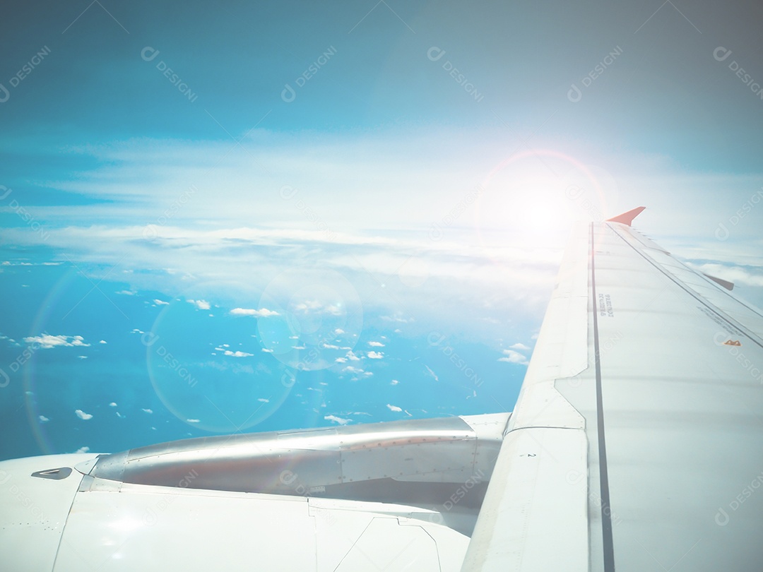 Lens flare e vista da asa do avião a jato com padrões de nuvens
