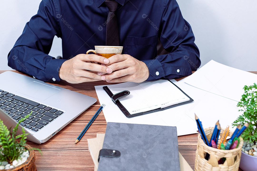 Homem de negócios tomando café em sua mesa