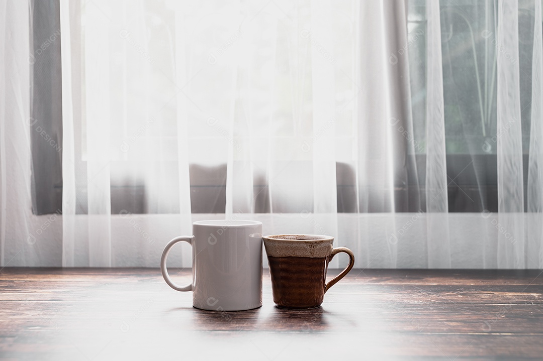 Glass of water and a mug of coffee are on the table.