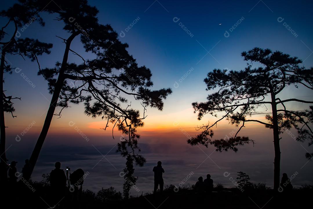 silhueta pessoas nascer do sol na montanha.
