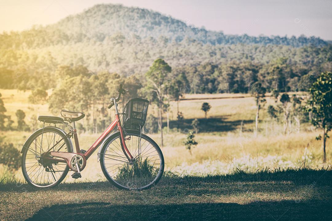 Vintage de bicicletas vermelhas estacionadas em uma colina ao pôr do sol.