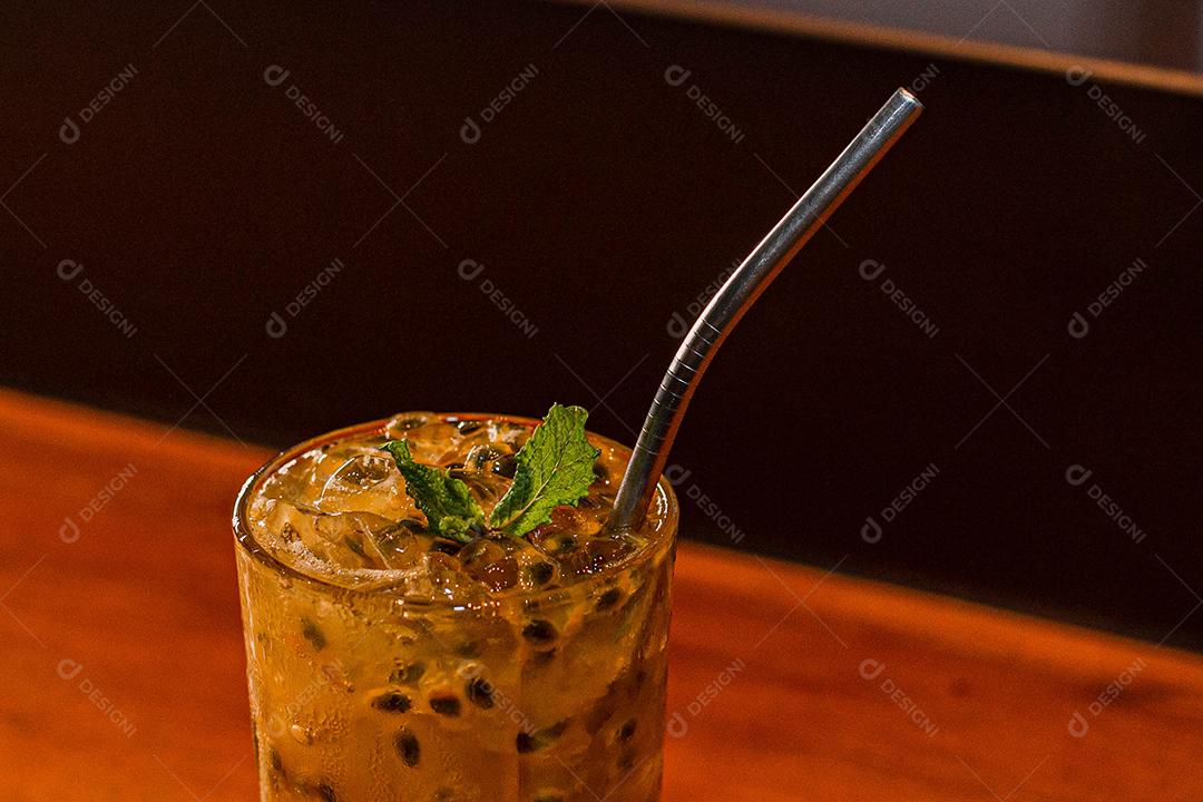 Passion fruit caipirinha with mint on a black background